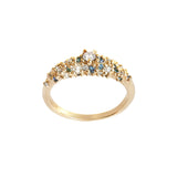 A product photo of Laurie Fleming Jewellery's "Blue-Green Sapphire and Diamond Mix Moss Signet Ring," a bold solid gold signet-style ring encrusted with varying shades and sizes of blue-green teal sapphires, round brilliant cut diamonds, and rose cut diamonds on the band. The ring is on a white background.
