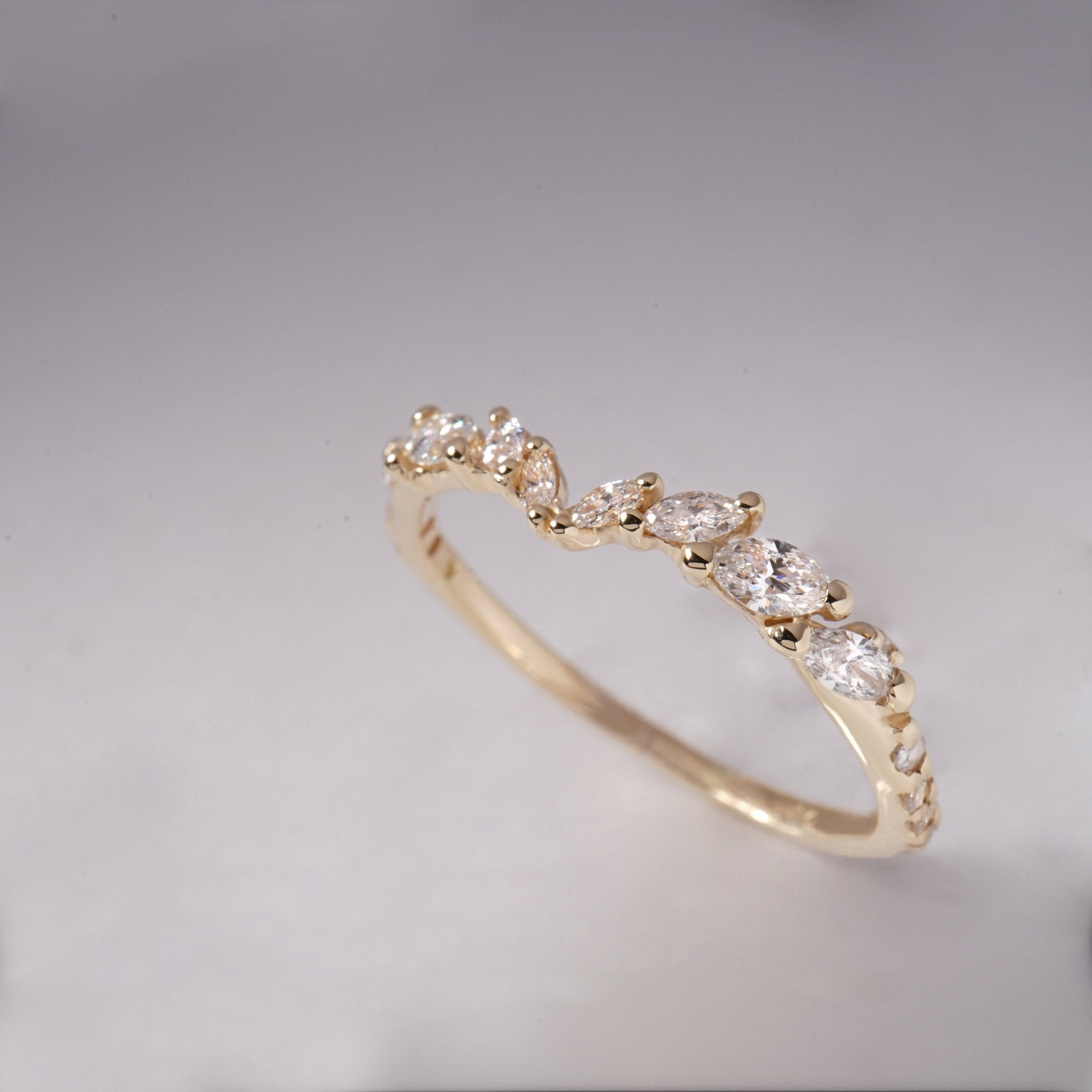 A product photo of the White Silk Jasmine Ring by Laurie Fleming Jewellery, featuring marquise cut diamonds in a gentle contoured V shape set in hand-carved solid gold. It stands against a plain medium grey background.