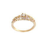 A product photo of Laurie Fleming Jewellery's "Pink Sapphire and Diamond Mix Moss Signet Ring," a bold solid gold signet-style ring encrusted with varying shades and sizes of light pink sapphires, round brilliant cut diamonds, and rose cut diamonds on the band. The ring is on a white background.