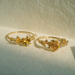 Two Asrai Garden Rings. Left: Sleeping Petal Band, Dahlia, Calla Lily, Diamond Dewdrops, Hidden Fairy. Right: Sleeping Petal Band, Peonies, Lilacs - Laurie Fleming Jewellery