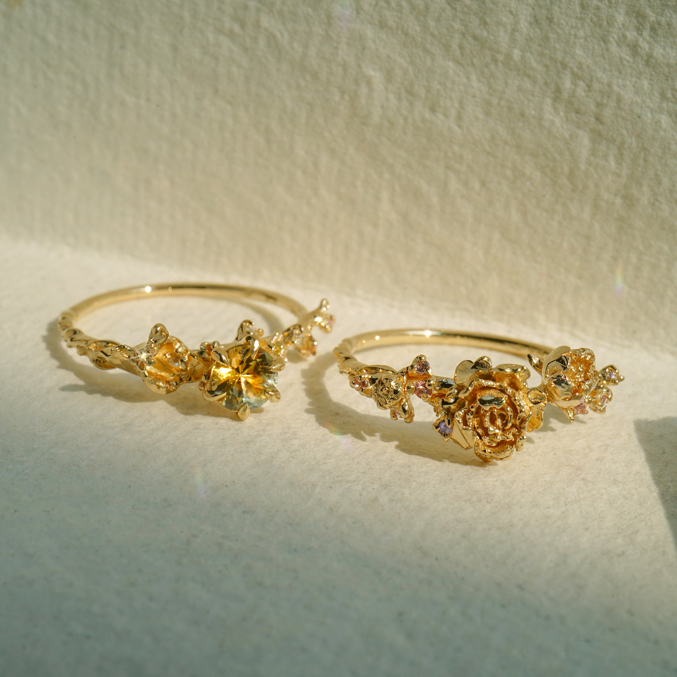 Two Asrai Garden Rings. Left: Sleeping Petal Band, Dahlia, Calla Lily, Diamond Dewdrops, Hidden Fairy. Right: Sleeping Petal Band, Peonies, Lilacs - Laurie Fleming Jewellery