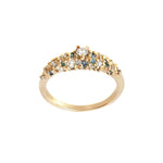 A product photo of Laurie Fleming Jewellery's "Blue-Green Sapphire and Diamond Mix Moss Signet Ring," a bold solid gold signet-style ring encrusted with varying shades and sizes of blue-green teal sapphires, round brilliant cut diamonds, and rose cut diamonds on the band. The ring is on a white background.