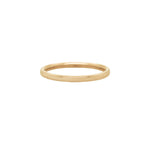 A stock photo of Laurie Fleming Jewellery's plain solid gold "Myrtle" band, a 1.4mm wide stacking ring/wedding band, handmade in Toronto. The ring is on a white background.