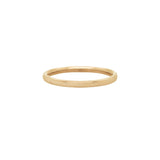 A stock photo of Laurie Fleming Jewellery's plain solid gold "Myrtle" band, a 1.4mm wide stacking ring/wedding band, handmade in Toronto. The ring is on a white background.