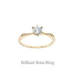 The Brilliant Diamond Ilona engagement ring with a delicate tapered band and sparkling diamond accents on the shoulders.