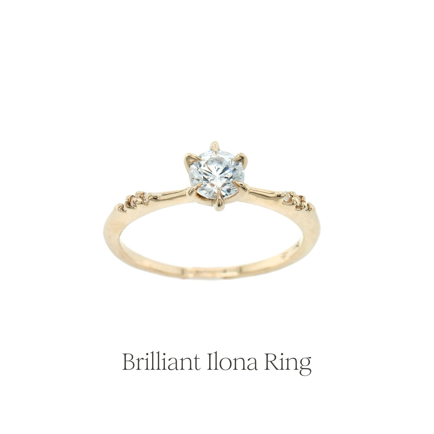 The Brilliant Diamond Ilona engagement ring with a delicate tapered band and sparkling diamond accents on the shoulders.