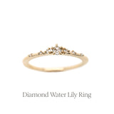 The delicate Diamond Water Lily Ring, with rose cut and round brilliant cut diamonds scattered along a knife-edge gold band, held in tiny hand-shaped claw prongs.