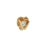 A product photo of a Pansy stud by Laurie Fleming Jewellery. It features a hand-carved miniature Pansy flower in solid 14k gold with a round brilliant cut diamond centre. The diamond can be swapped out for any birthstone. 