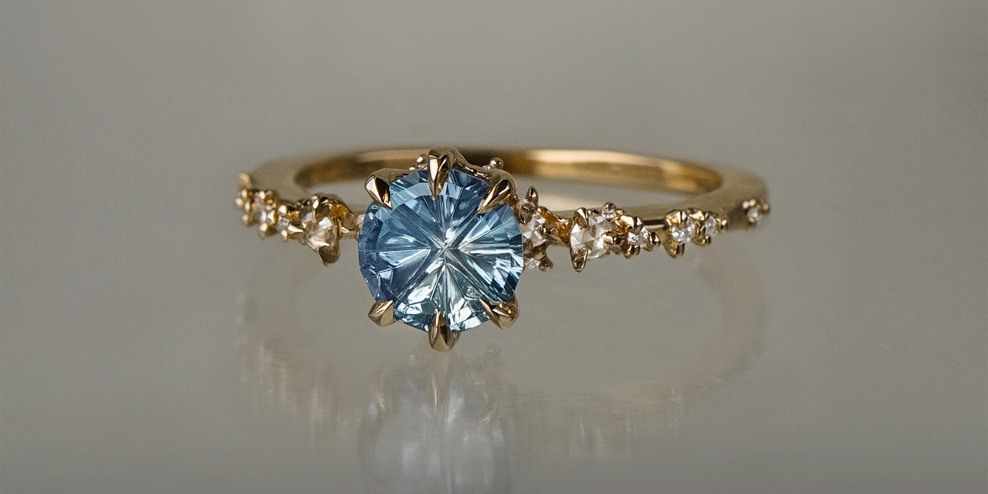 One of a kind Nereid ring featuring a round John Dyer Starbrite cut light blue sapphire centre - Laurie Fleming Jewellery