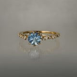 One of a kind Nereid ring featuring a round John Dyer Starbrite cut light blue sapphire centre - Laurie Fleming Jewellery