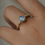 One of a kind Nereid ring featuring a round John Dyer Starbrite cut light blue sapphire centre - Laurie Fleming Jewellery