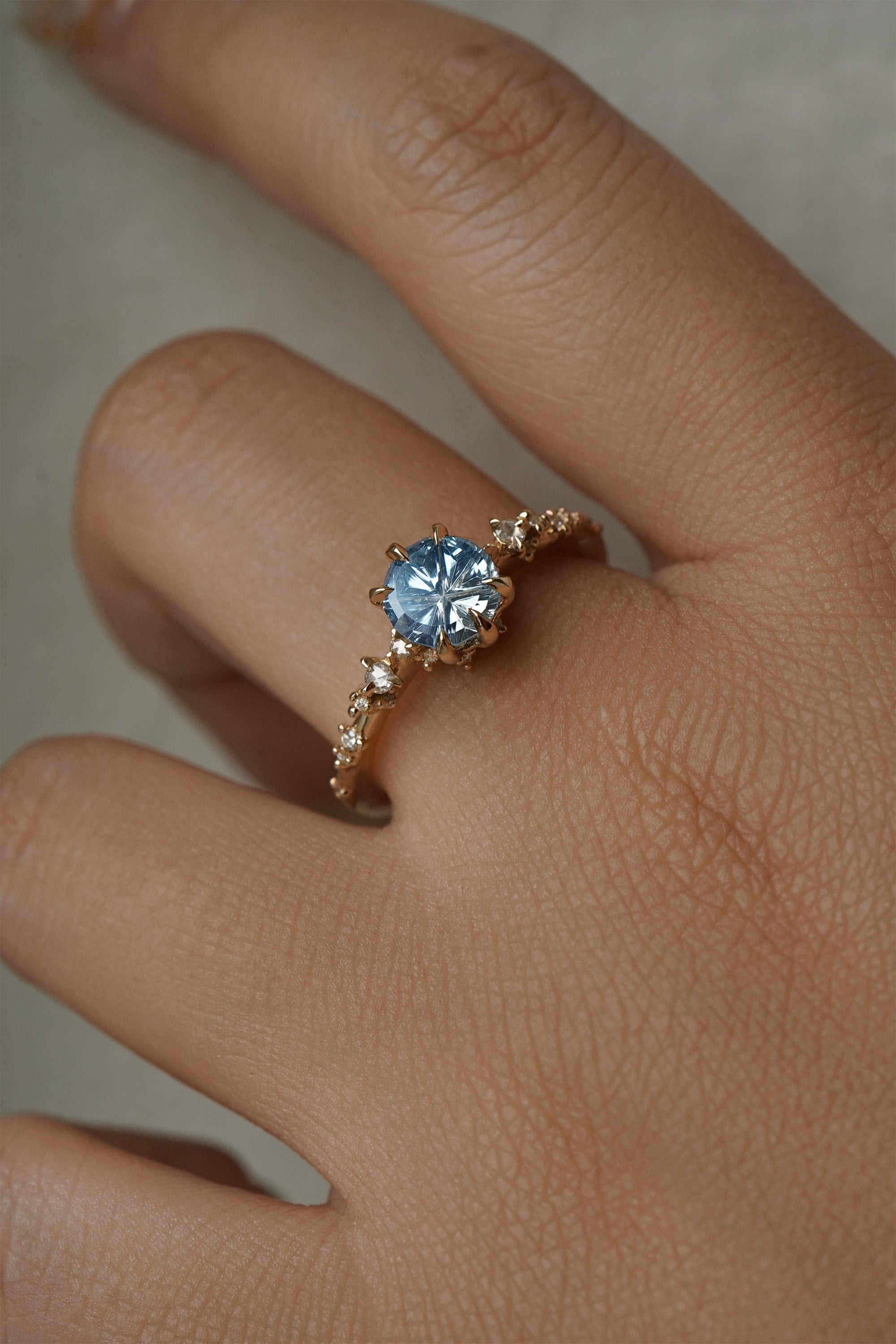 One of a kind Nereid ring featuring a round John Dyer Starbrite cut light blue sapphire centre - Laurie Fleming Jewellery