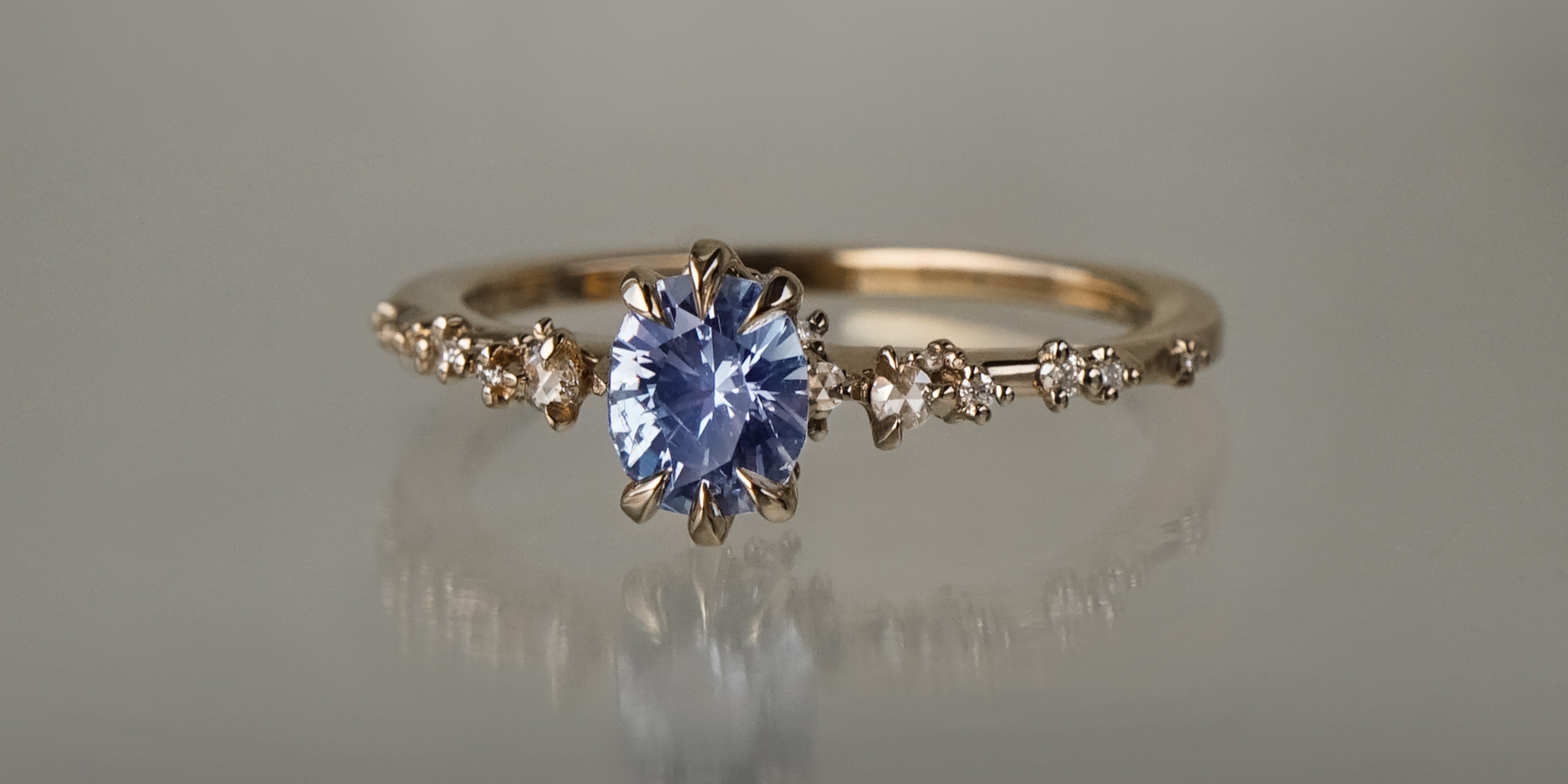 One of a kind Nereid ring featuring an oval artist cut light blue-violet sapphire centre - Laurie Fleming Jewellery