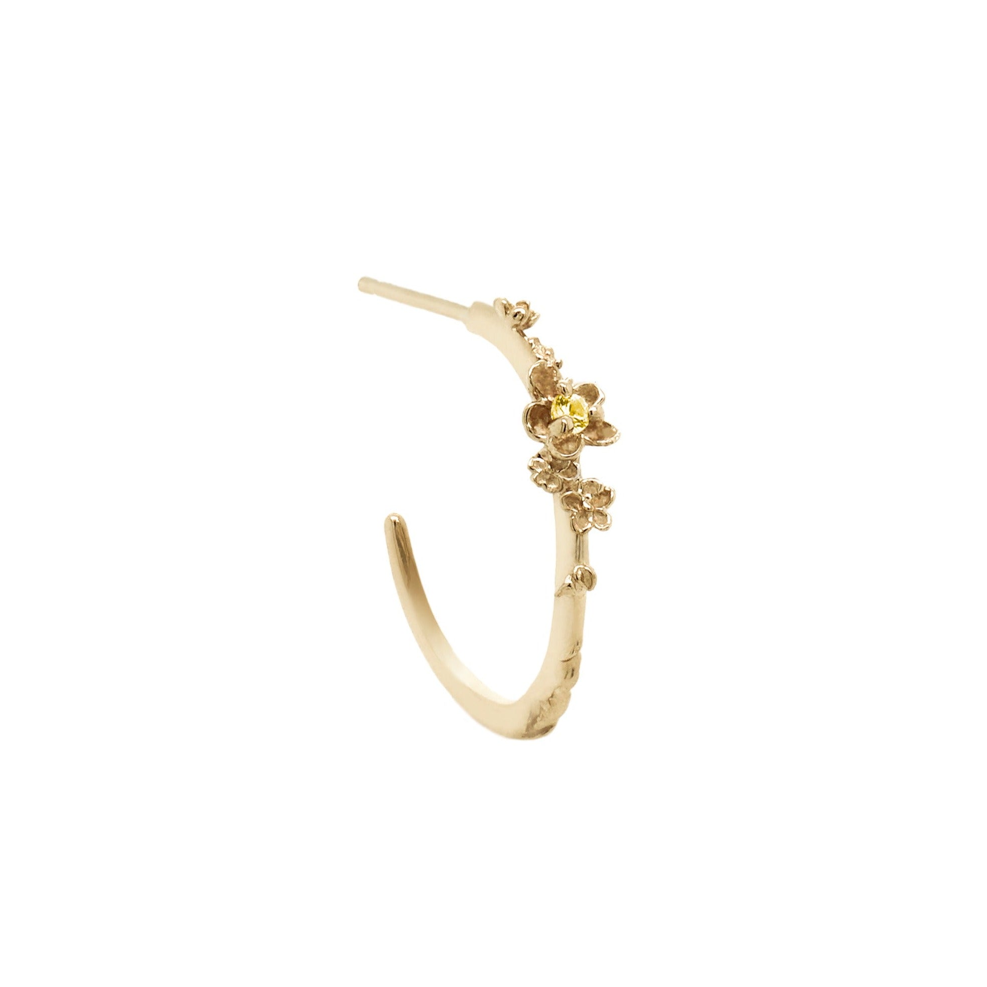 Laurie Fleming Jewellery "Large Buttercup Hoop" earring, featuring petite hand-carved buttercup flowers with a yellow sapphire centre. The earring is on a white background.