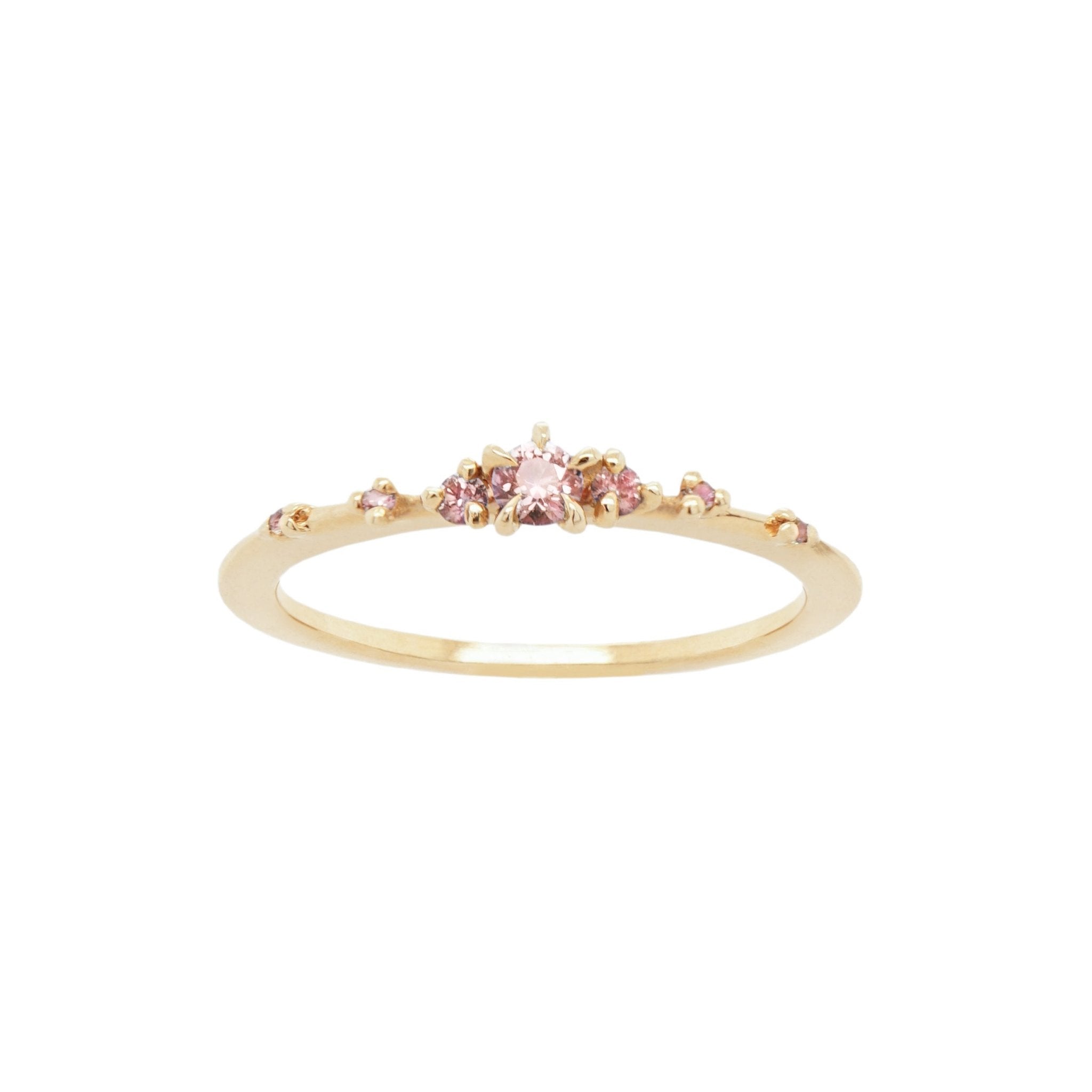 Laurie Fleming Jewellery's "Pink Sapphire Water Lily Ring," a delicate solid gold stacking ring with light pink sapphires scattered along the band. The ring is on a white background.