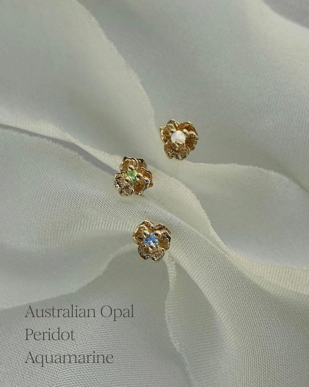 Three Pansy Stud Earrings with different centre stones. From top to bottom: Australian Opal, Peridot, Aquamarine - Laurie Fleming Jewellery