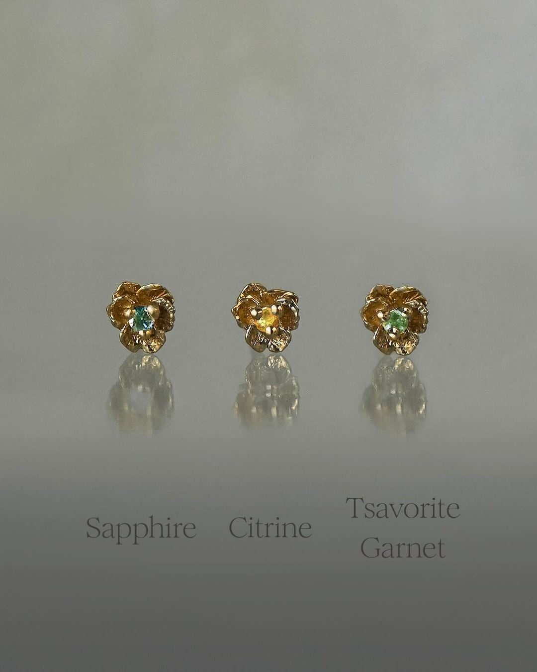 Three Pansy Stud Earrings with different centre stones. From Left to Right: Sapphire, Citrine, Tsavorite Garnet - Laurie Fleming Jewellery