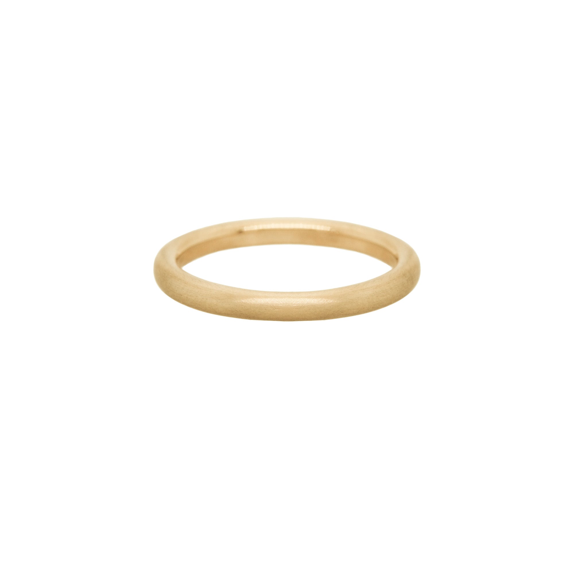 A stock photo of Laurie Fleming Jewellery's plain solid gold "Peach" band, a 2.1mm wide round wire stacking ring/wedding band, handmade in Toronto. The ring has a soft satin brushed finish and is on a white background.