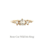 The Rose Cut Diamond Wild Iris three-stone engagement ring by Laurie Fleming Jewellery, features three rose cut diamonds at the centre (one larger and a smaller one on either side) with additional small diamond accents on the band.