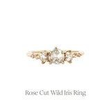 The Rose Cut Diamond Wild Iris three-stone engagement ring by Laurie Fleming Jewellery, features three rose cut diamonds at the centre (one larger and a smaller one on either side) with additional small diamond accents on the band.