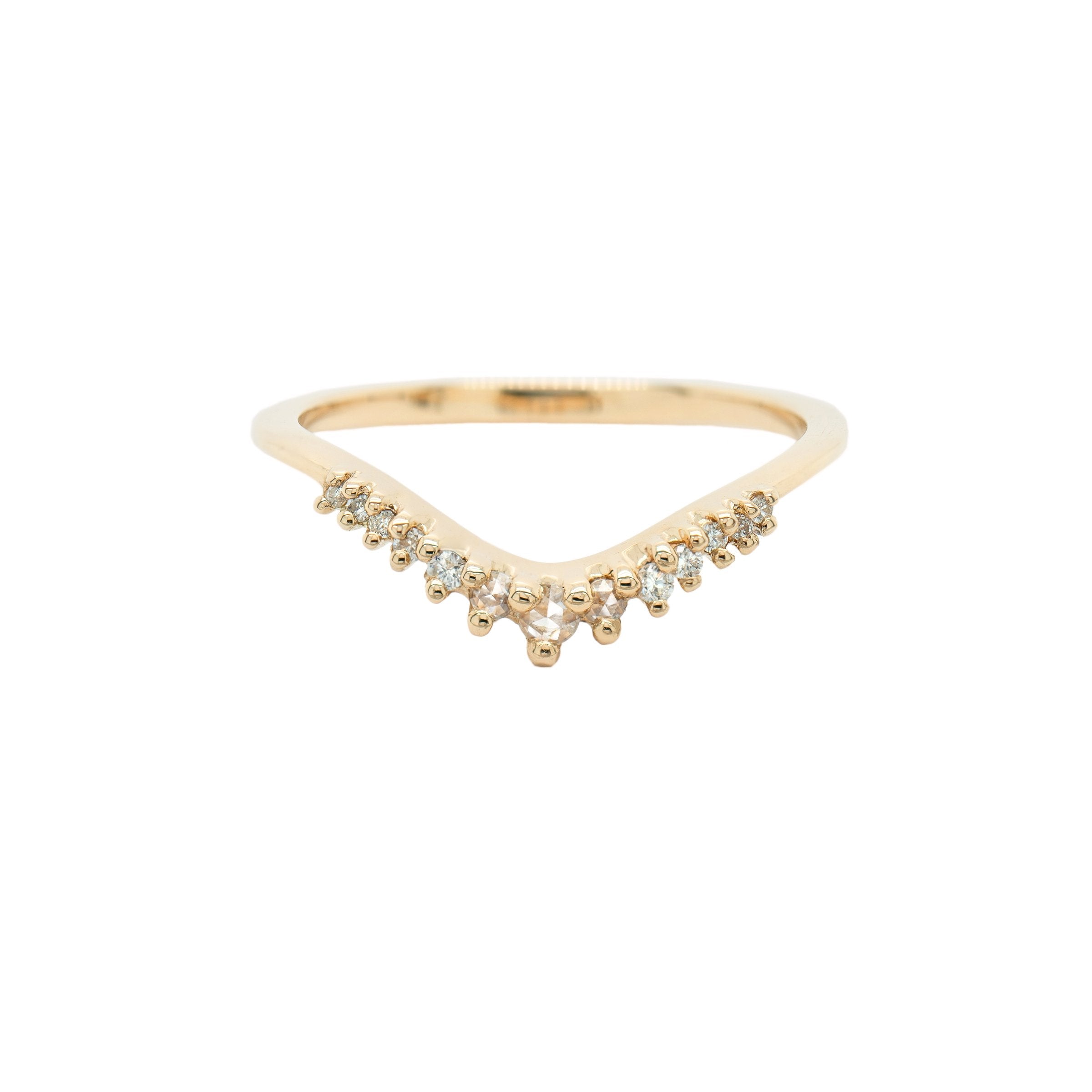 A solid gold Selene contour band ring by Laurie Fleming Jewellery, which features rose cut and brilliant cut diamonds along a curve to stack with other rings (such as with an engagement ring). The ring is against a white background.