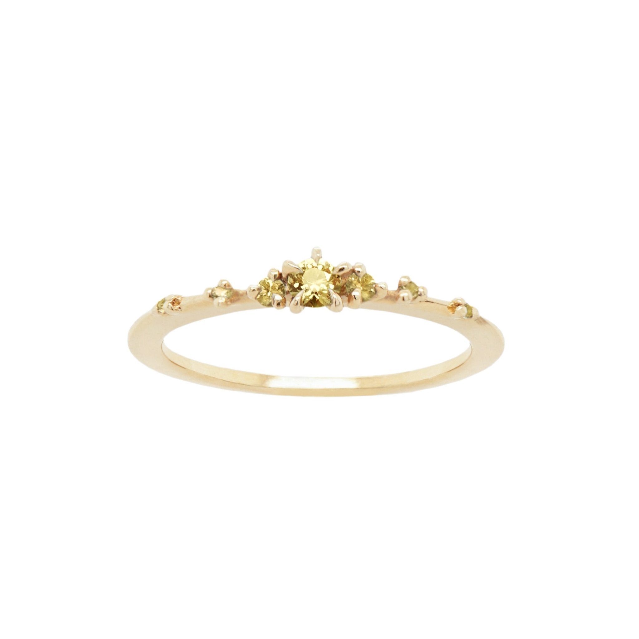 Laurie Fleming Jewellery's "Yellow Sapphire Water Lily Ring," a delicate solid gold stacking ring with yellow sapphires scattered along the band. The ring is on a white background.