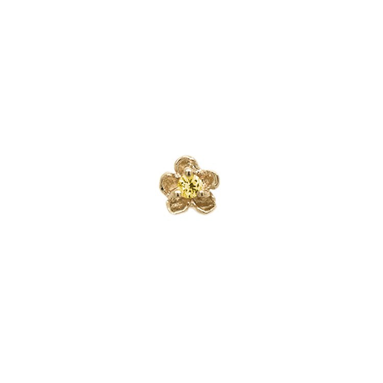 Laurie Fleming Jewellery "Buttercup Stud" earring, featuring a petite hand-carved buttercup flower with a yellow sapphire centre. The earring is on a white background.